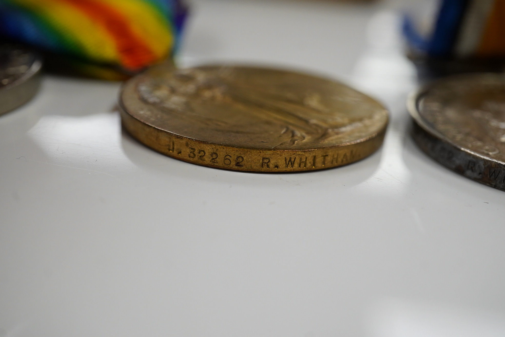 A WWI and WWII medal group awarded to R. Whitham A.B. R.N.; a First World War medal trio with a George V Long Service and Good Conduct Medal, together with a 1939-1945 Medal, the Atlantic Star, and the 1939-1945 Star. Co